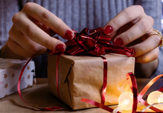 woman wrapping gift